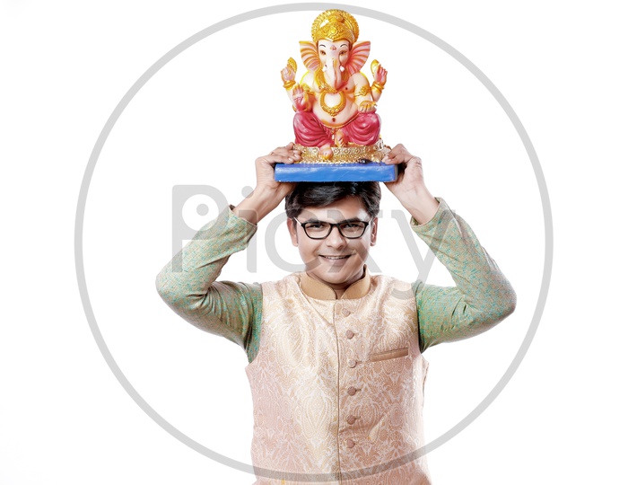 Indian Young Man With Lord Ganesh Idol on an Isolated White Background