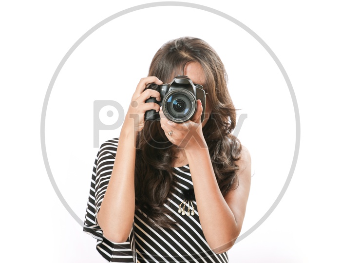 Indian girl  photo with digital camera/ DSLR holding in hands  on white background