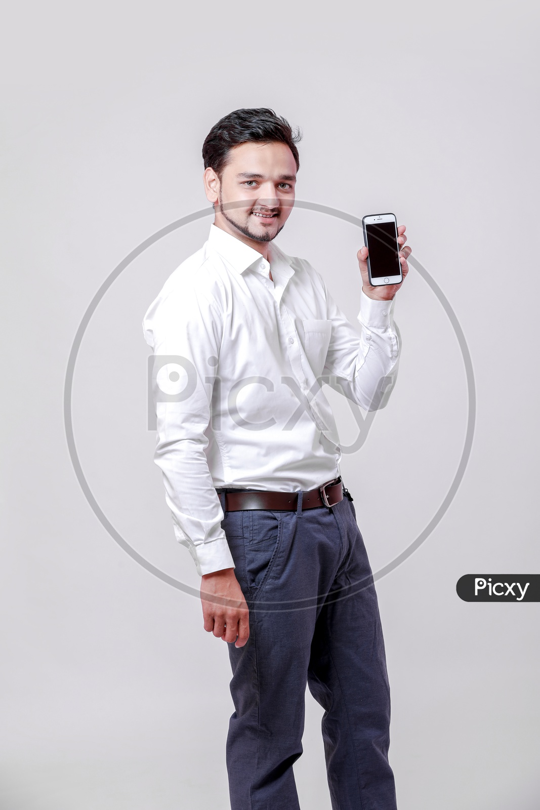 Indian Young Professional Man With a Smiling Face and Showing  Mobile  On an Isolated White Background
