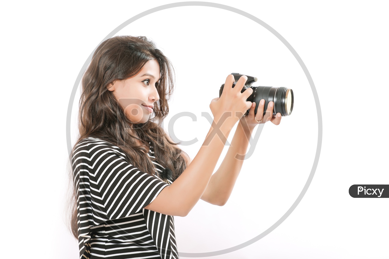 Indian girl take a photo with digital camera on white background