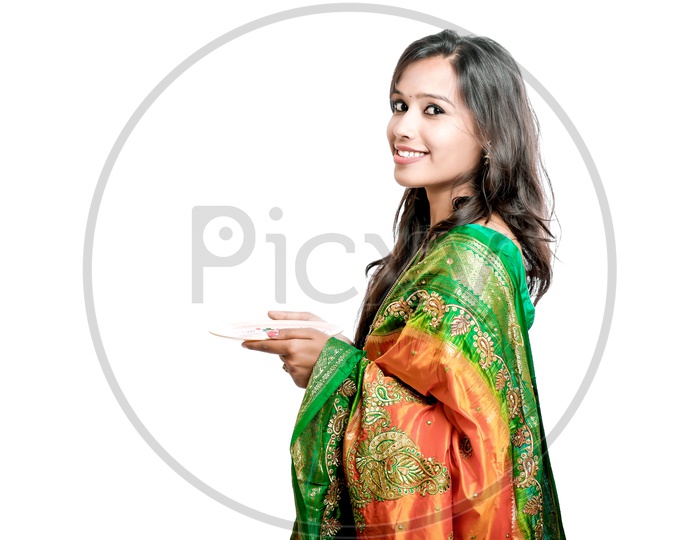 Indian Young Lady Wearing Saree And Carrying on Palms On an Isolated White Background