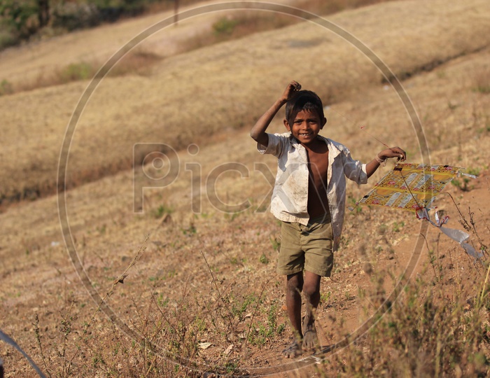 indian village kid playing with kite