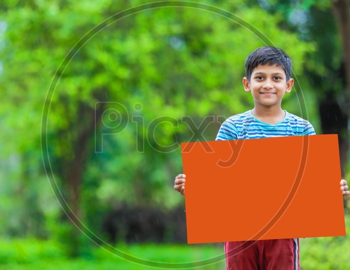 Indian Boy child Showing Placard and smiling