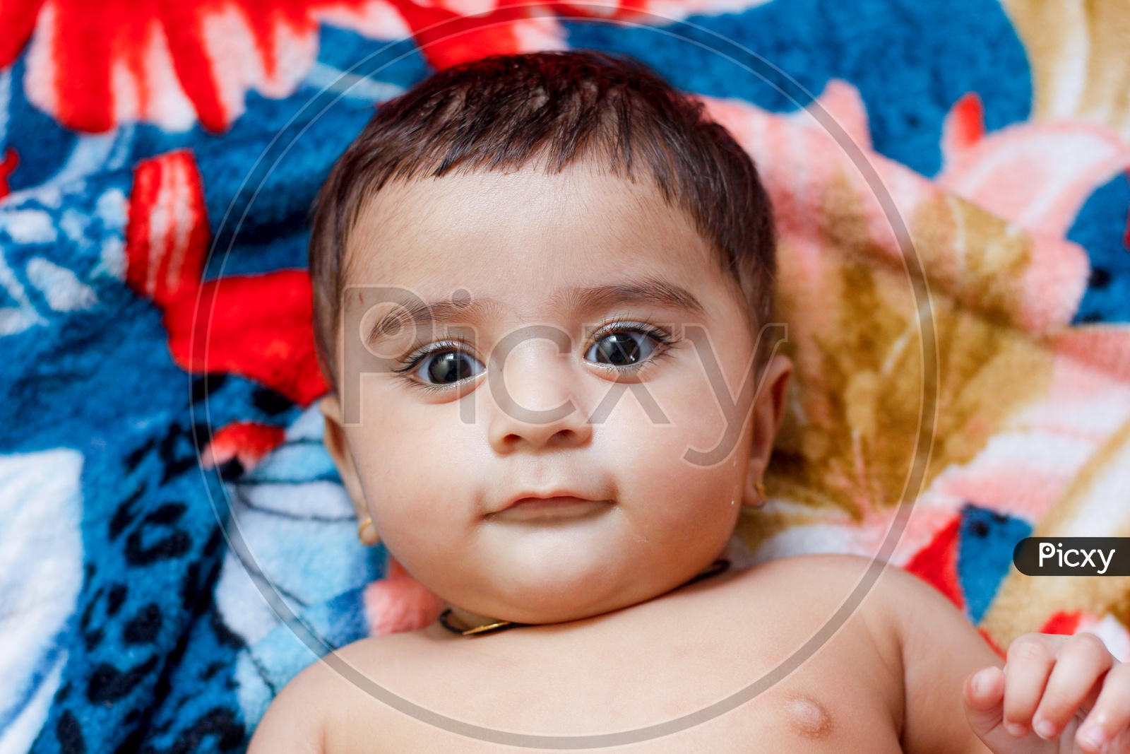 Indian Cute Baby Boy Closeup Shot Lying on a Bed with An Expression on Face