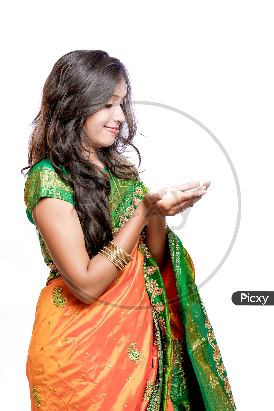 Indian Young Lady Wearing Saree And Carrying on Palms On an Isolated White Background