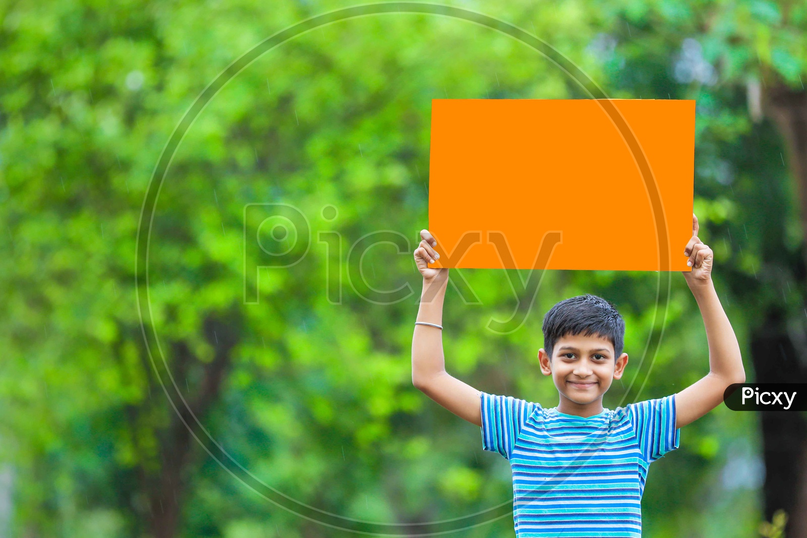 Indian Boy Showing an Empty Placard With a Smile  on Face