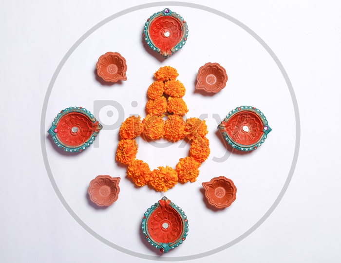Indian Diwali Lamps / Diya With Marigold Flowers Closeup Shot on a White Background