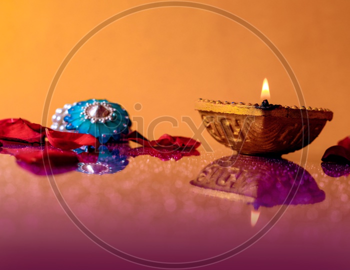 Diwali Indian Festival Diya or lamp with orange background / Lightened Up Diya / Diwali Festival of India