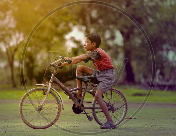 Indian Boy Child Riding Bicycle in Rural India