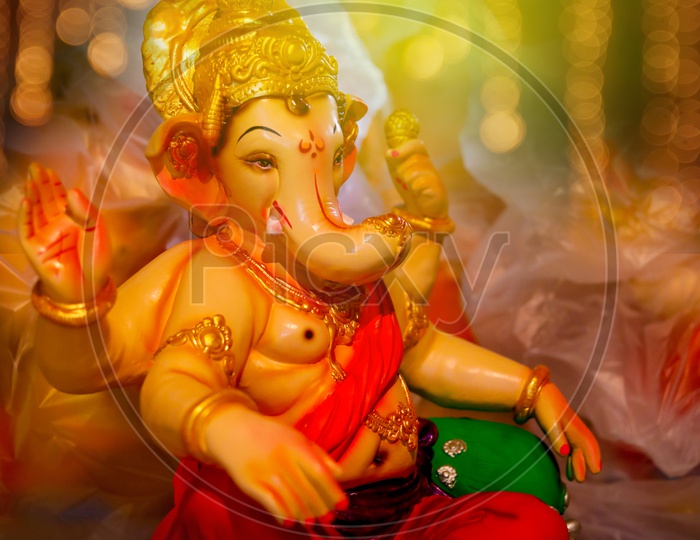 Close up shot of Lord Ganesha Idol with beautiful bokeh background / Ganesh