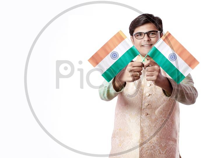 Handsome Indian boy or man in white ethnic wear holding indian national flag