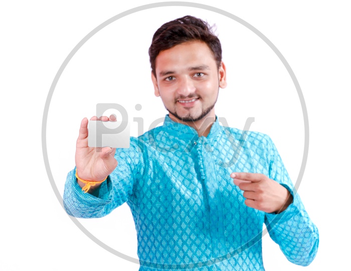 Indian Young Professional Man With a Smiling Face and Holding An Empty Card  On an Isolated White Background