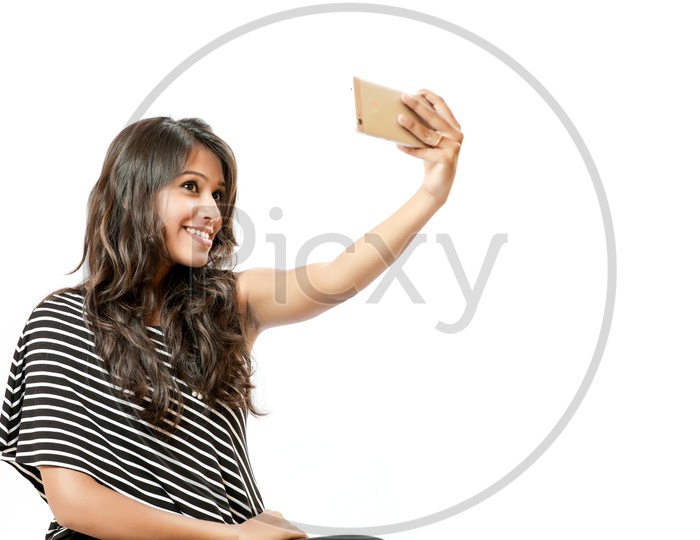 Indian Young Girl Taking a Selfie With a Smiling Face on an Isolated White Background