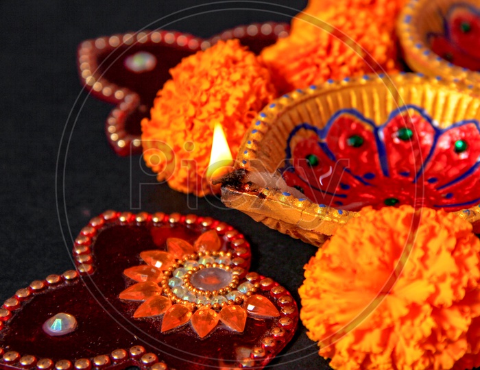 Diwali Indian Festival Diya or lamp with black background / Lightened Up Diya