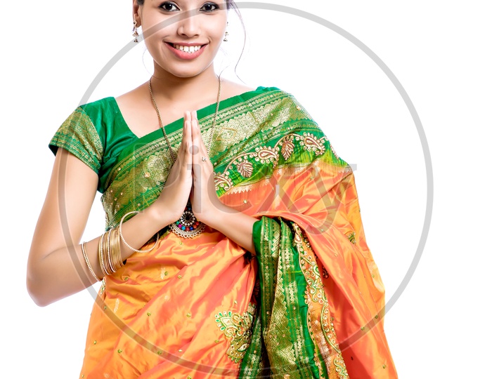 Indian Young Lady Wearing Saree and Saying Namaste Gesture On An Isolated White Background