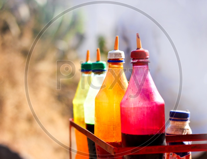 Coloured Sugar Syrup Bottles Of Ice Gola ( Indian Street Food )  Closeup Shot