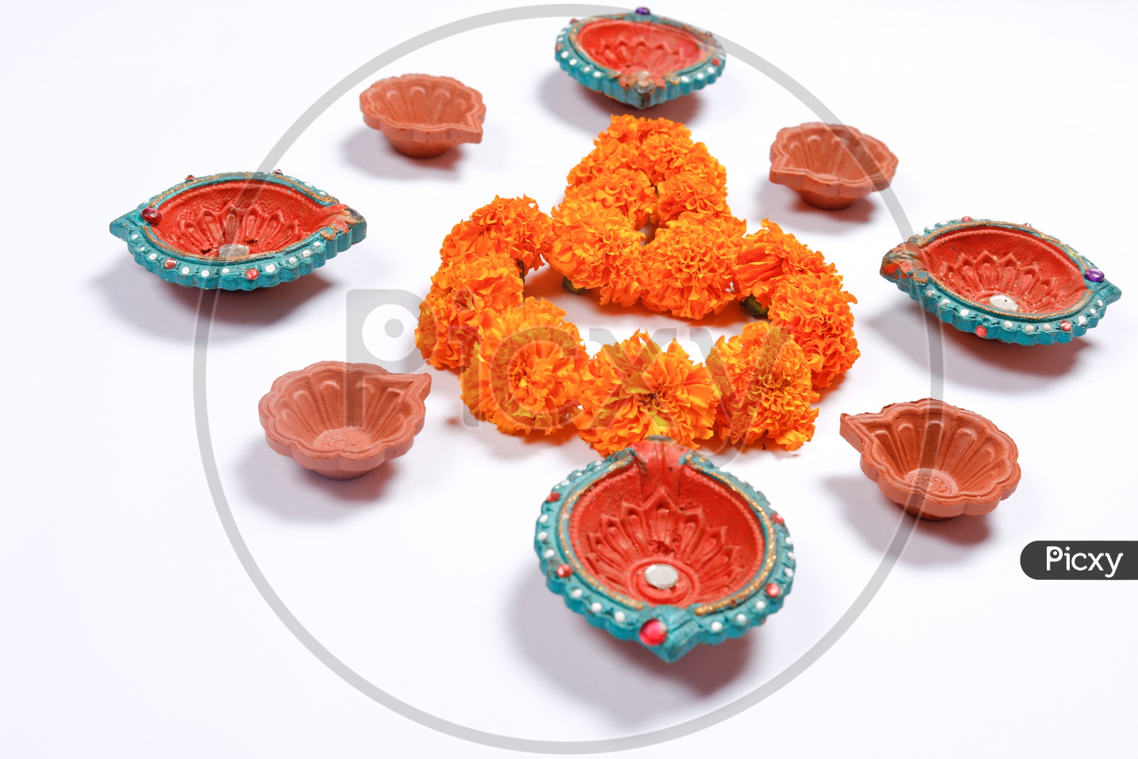 Indian Diwali Lamps / Diya With Marigold Flowers Closeup Shot on a White Background