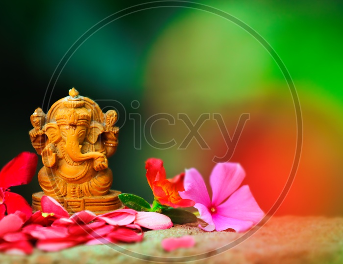 Ganesh Idol with  beautiful flowers in the foreground