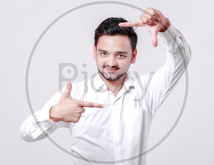 Indian Young Professional Man With a Smiling Face and With Gestures   On an Isolated White Background