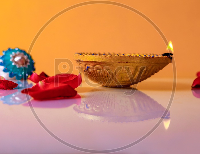 Diwali Indian Festival Diya or lamp with yellow background / Lightened Up Diya / Diwali Festival of India