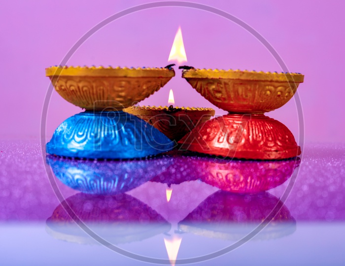 Diwali Indian Festival Diya or lamp with pink background / Lightened Up Diya / Diwali Festival of India