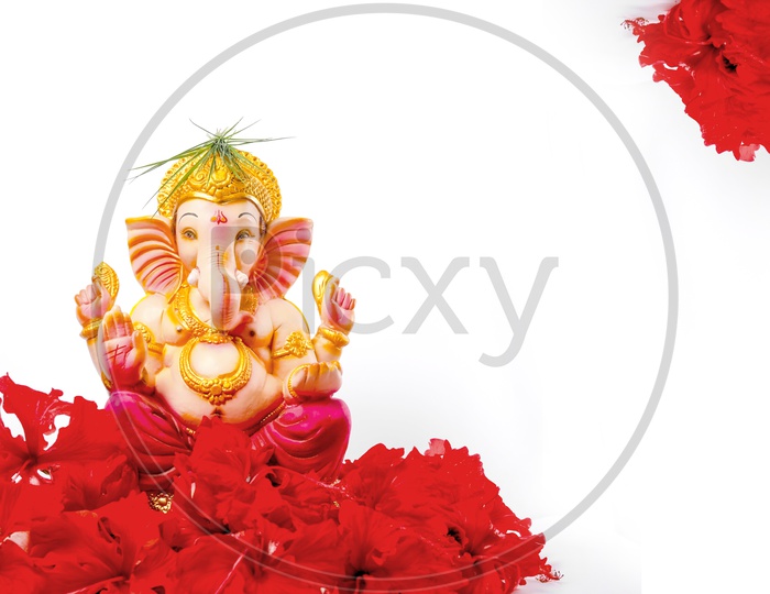 Lord Ganesh Idol with beautiful red flowers in the foreground