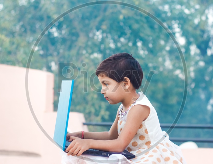 Indian Girl Child With Laptop