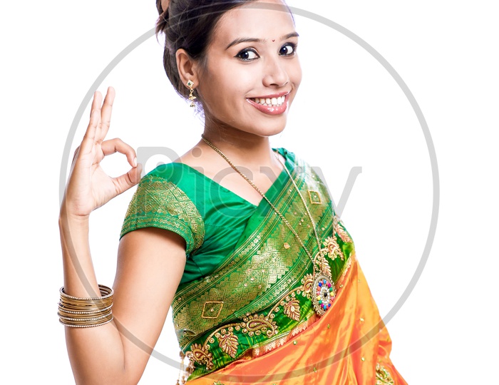 Indian Young Lady Wearing Saree And Showing Gestures With a Smiling Face on an Isolated White Background
