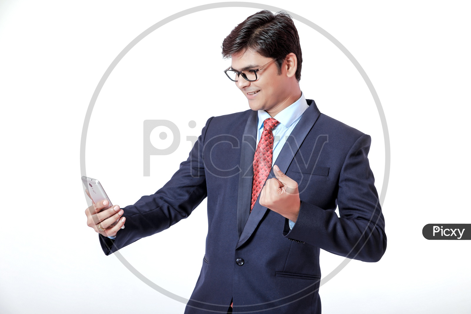Indian Young Professional Man In Suite Speaking on Phone  with a Smile On Face  and with Gestures