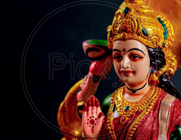 close up shot of sri lakshmi devi idol with black background
