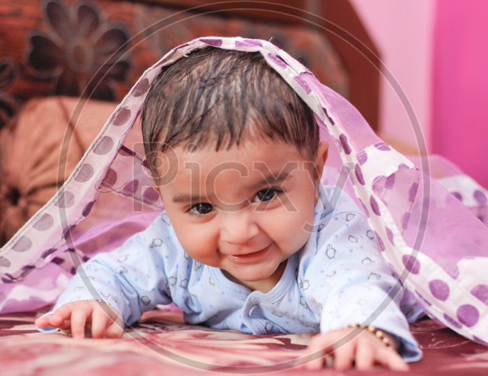 Indian Cute Baby Boy With a Smiling Face lying on bed