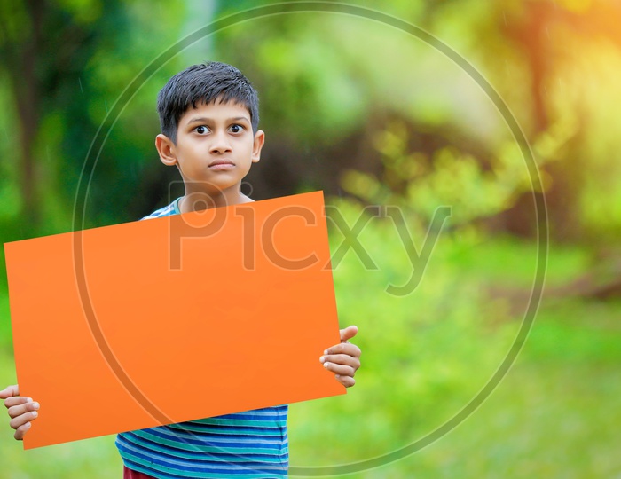 Indian Boy Showing an Empty Placard With an Expression  on Face