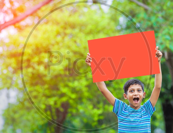 Indian Boy child Showing Placard and laughing Louder