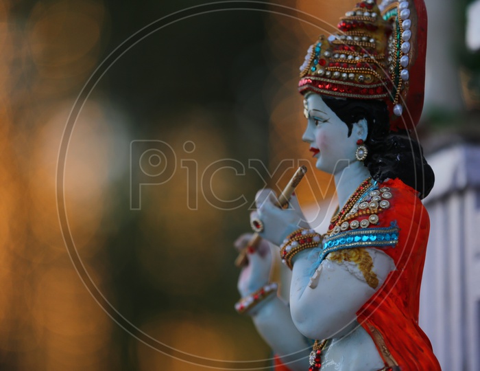 Idol of Lord Sri Krishna with bokeh background