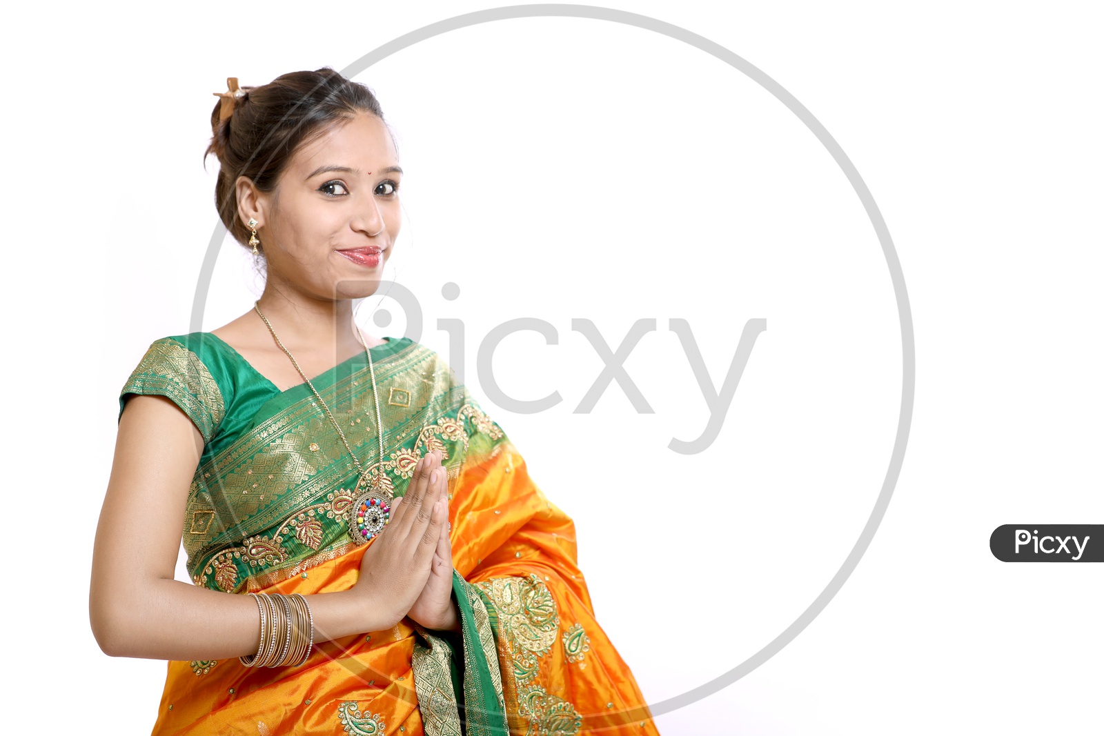Indian Young Lady Wearing Saree and Saying Namaste Gesture On An Isolated White Background