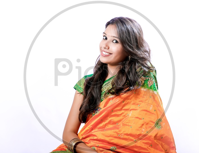 Indian Young Lady wearing a Saree with a Smiling Face on an Isolated White Background