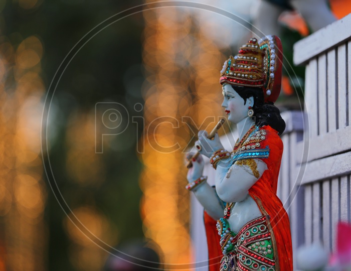 Idol of Lord Sri Krishna with bokeh background