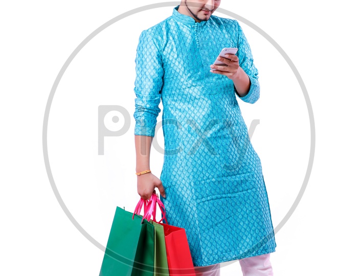 Indian Young Man With Shopping Bags And With Mobile on Hand on an isolated White Background