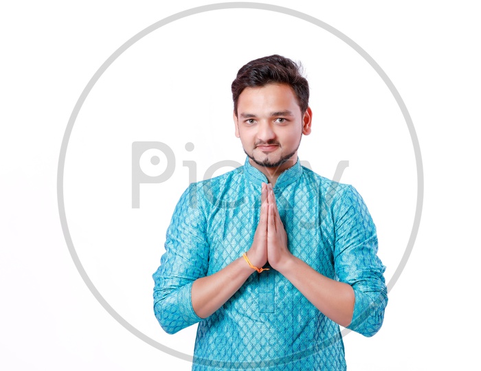 Indian Young Man With Shopping Bags And With a Smiling face and Saying Namaste Gesture on an isolated White Background