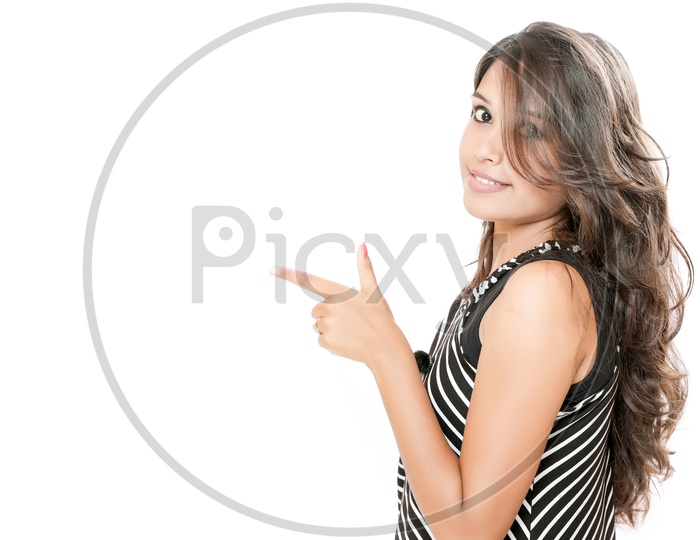 Indian Young Girl With Cute Expressions and Showing Space  on an Isolated White Background