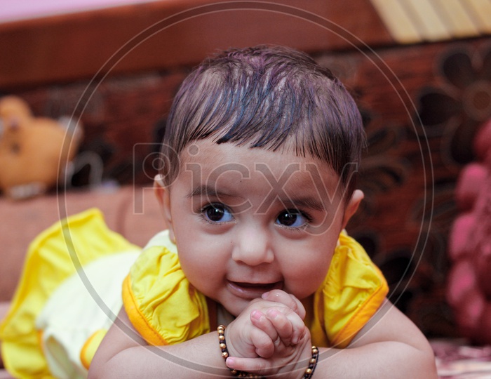 Indian Cute Baby Closeup Shots With Expressions Lying on a Bed in Home