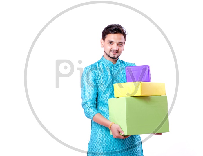 Portrait of a happy Indian Men carrying gifts in hands  with white background