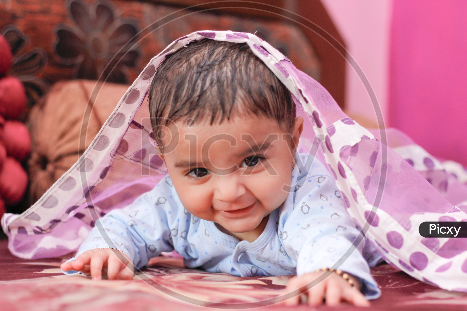 Indian Cute Baby Boy With a Smiling Face lying on bed