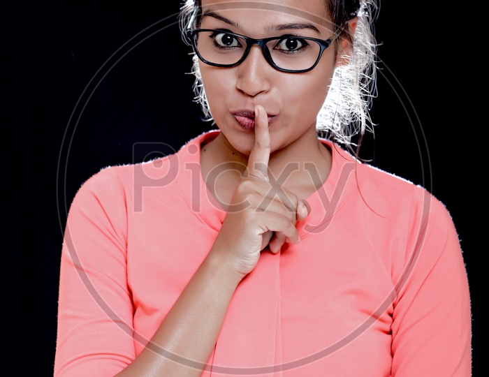 Indian Young Girl With Cute Expressions on an Isolated Black  Background