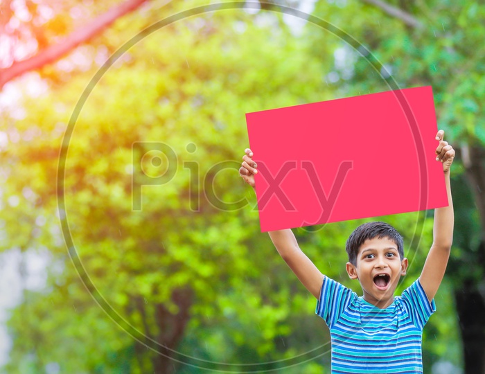 Indian Boy Showing an Empty Placard With a Smile  on Face