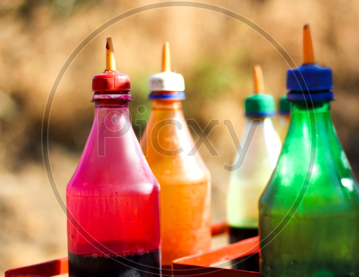 Coloured Sugar Syrup Bottles Of Ice Gola ( Indian Street Food )  Closeup Shot