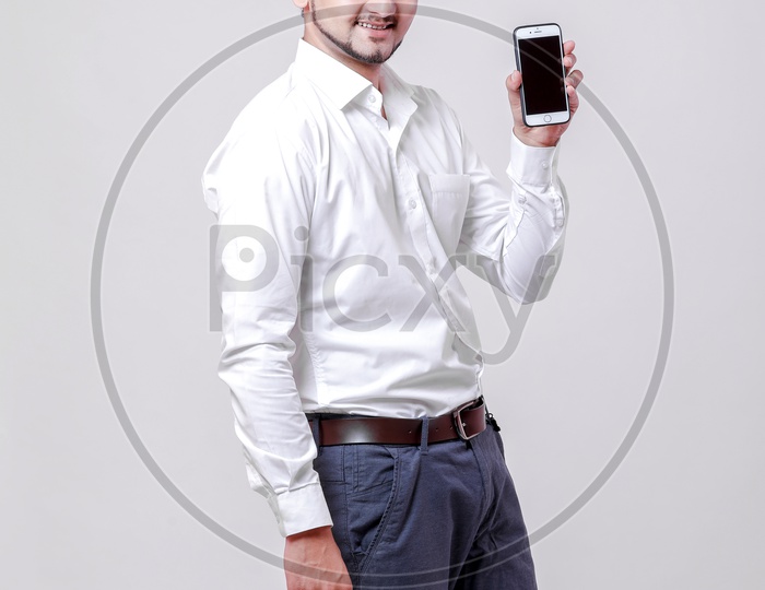 Indian Young Professional Man With a Smiling Face and Showing  Mobile  On an Isolated White Background