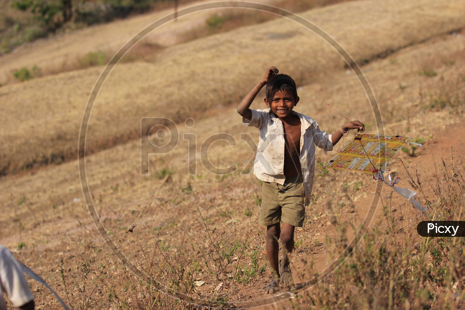 indian village kid playing with kite