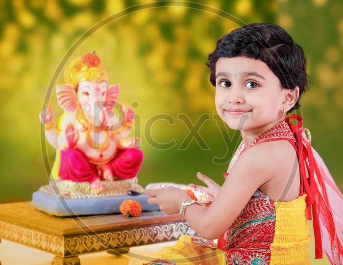 Indian Girl Child With Lord Ganesh Statue