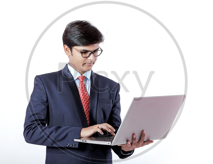 Indian Young Professional Man In Suite  with Laptop in Hand